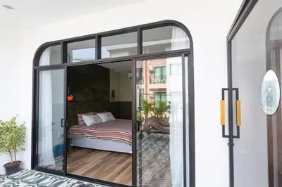 a room with a glass door with a bed in it at Cozy Patong Beach House 3 Bedrooms in Patong Beach