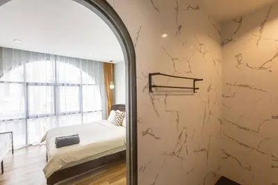 a bedroom with a bed and a wall with a mirror at Cozy Patong Beach House 3 Bedrooms in Patong Beach