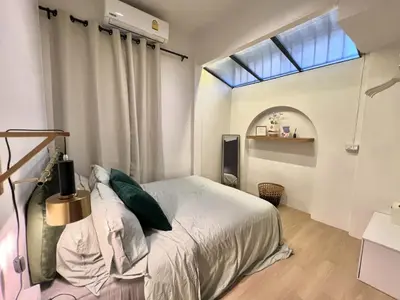 a bedroom with a bed and a large window at Surfer House Patong Center 3 Bedrooms in Patong Beach