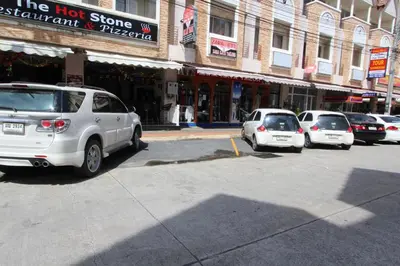 a group of cars parked in front of a building at Sleep Easy in Kata Beach