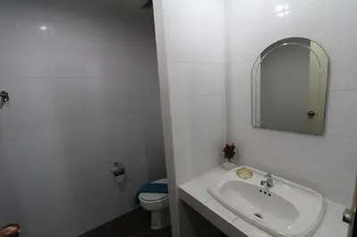 a bathroom with a sink and a mirror and a toilet at Sleep Easy in Kata Beach