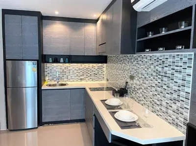 a kitchen with gray cabinets and a refrigerator at Luxury private apartment Citygate by Lofty in Kamala Beach