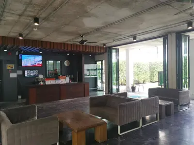 a lobby with a waiting area with chairs and a table at Rawai beachfront - One bedroom on 3 floor at Title in Rawai Beach