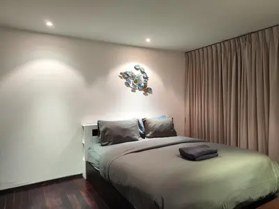 a bedroom with a large bed in a room at Rawai beachfront - One bedroom on 3 floor at Title in Rawai Beach