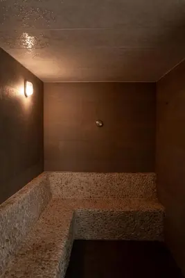 a room with a large stone bench on a wall at Title V Pool View 3fl Gym Hammam Rawai in Rawai Beach