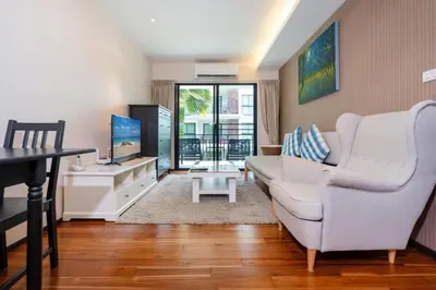 a living room with a white couch and a tv at New Apartment TTL B209 in New Rawai Beach Residence with Tropical Pools in Rawai Beach