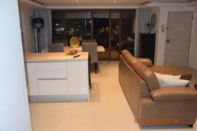 a kitchen and living room with a couch and a table at KALIM RESIDENCE unit 132 VUE MER in Patong Beach