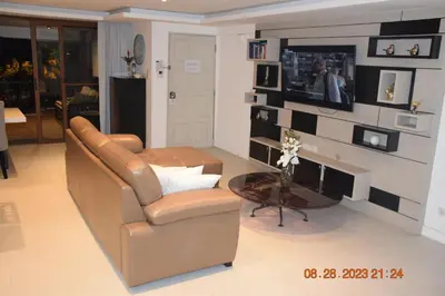 a living room with a couch and a television at KALIM RESIDENCE unit 132 VUE MER in Patong Beach