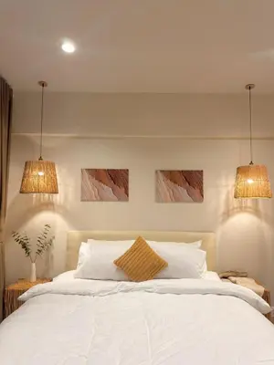 a bedroom with a white bed with two lights at TIL DAWN Phuket in Karon Beach