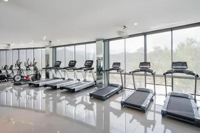 a gym with a row of cardio machines at Kamala Beach D76 Exclusive Junior Suite in Kamala Beach