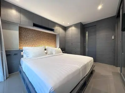a bedroom with a large white bed in it at Kamala Beach D76 Exclusive Junior Suite in Kamala Beach
