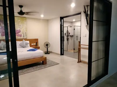 a bedroom with a bed and a walk in shower at Beautiful private 4 bedroom villa with pool and gym in Rawai Beach