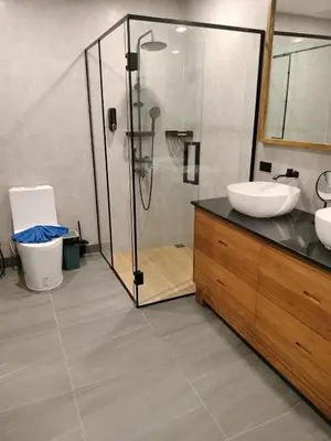 a bathroom with a glass shower and a sink at Beautiful private 4 bedroom villa with pool and gym in Rawai Beach