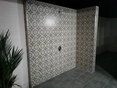 a bathroom with a tile wall with a hole in it at Beautiful private 4 bedroom villa with pool and gym in Rawai Beach