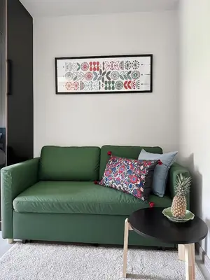a green couch in a living room with a table at Great Hill Cozy Stay Pool Gym Naiyang in Phuket Town