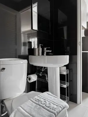 a bathroom with a white toilet and a sink at Great Hill Cozy Stay Pool Gym Naiyang in Phuket Town
