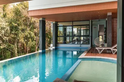 a swimming pool in a house with a view of a house at Great Hill Cozy Stay Pool Gym Naiyang in Phuket Town