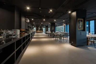 a restaurant with tables and chairs and a long corridor at Kamala Beach P67 Exclusive Junior Suite in Kamala Beach