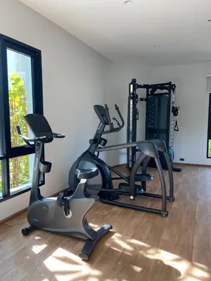 a gym with two tread machines in a room at Title V Sunny Holiday Pool View Gym Hammam in Rawai Beach