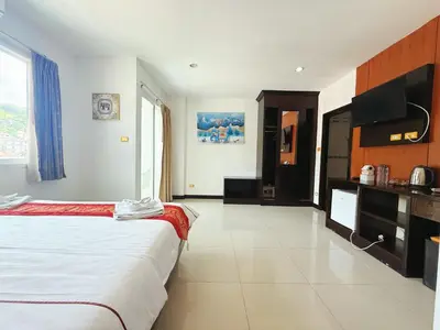 a hotel room with a bed and a kitchen at Abby's House Hotel in Patong Beach