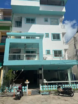 two motorcycles parked in front of a building at Abby's House Hotel in Patong Beach