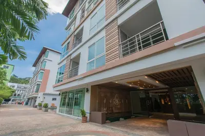 a building on a street next to a sidewalk at Haven Lagoon Condominium in Patong Beach