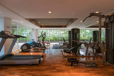 a gym with a bunch of treadmills and machines at Haven Lagoon Condominium in Patong Beach