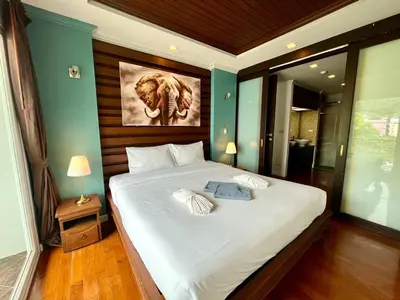 a bedroom with a bed with a picture of an elephant at Haven Lagoon Condominium in Patong Beach