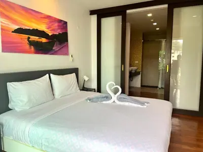 a bedroom with a bed with a heart on it at Haven Lagoon Condominium in Patong Beach