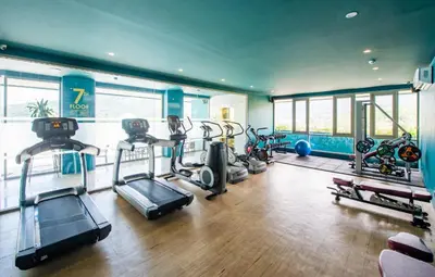 a gym with several treadmills and machines in it at Oceana Resort Kamala Ocean View 5th floor in Kamala Beach