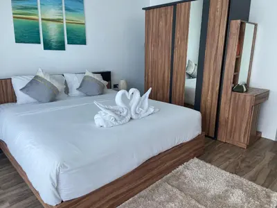 a bedroom with a bed with white towels on it at Oceana Resort Kamala Ocean View 5th floor in Kamala Beach
