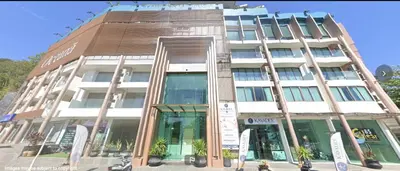 a tall white building with a lot of windows at Oceana Resort Kamala Ocean View 5th floor in Kamala Beach