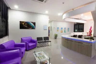 a hospital lobby with purple chairs and a counter at Kamala Beach P55 Exclusive Junior Suite in Kamala Beach