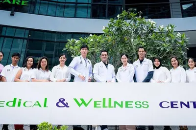a group of people standing behind a white banner at Kamala Beach P55 Exclusive Junior Suite in Kamala Beach