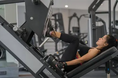 a woman laying on a machine in a gym at Kamala Beach P55 Exclusive Junior Suite in Kamala Beach