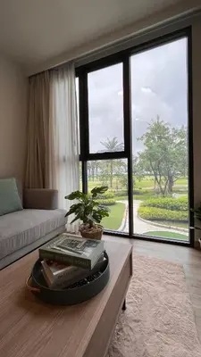 a living room with a table with books and a window at Sky Park Laguna 1 bedroom Golf View in Bang Tao Beach