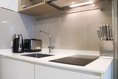 a kitchen counter with a sink and a microwave at Sky Park Laguna 1 bedroom Golf View in Bang Tao Beach