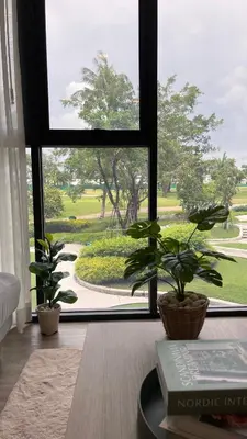 a room with a window with plants and a book at Sky Park Laguna 1 bedroom Golf View in Bang Tao Beach