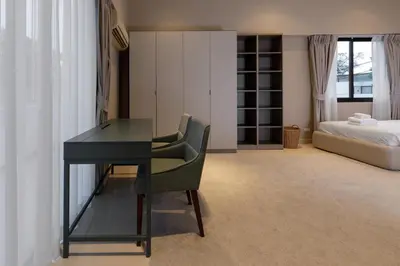 a desk and a chair in a room with a bed at Modern villa with pool close to the beach - LP #97 in Phuket Town