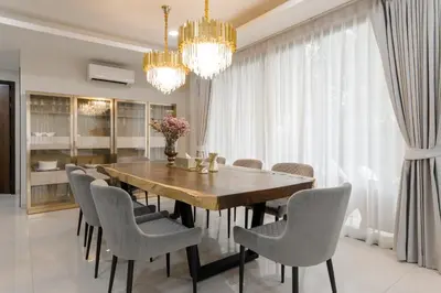 a dining room with a wooden table and chairs at Modern villa with pool close to the beach - LP #97 in Phuket Town