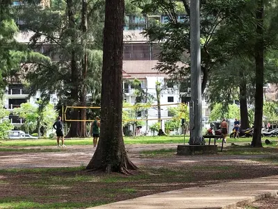 a park with trees and people in a park at Nai Harn beach - Studio room on 2 floor at ReLife The Windy in Rawai Beach