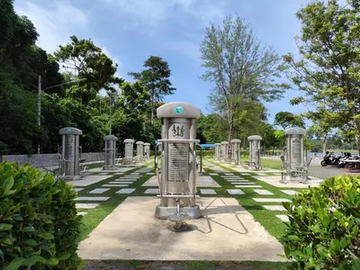 a cemetery with a line of tombstones in the grass at Nai Harn beach - Studio room on 2 floor at ReLife The Windy in Rawai Beach