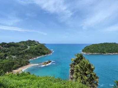 a view of a beach with palm trees and the ocean at Nai Harn beach - Studio room on 2 floor at ReLife The Windy in Rawai Beach