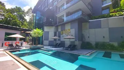 a swimming pool in front of a building at Silk Ao Nang Condominium in Ao Nang Beach