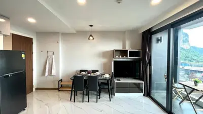 a dining room with a table and chairs in a kitchen at Silk Ao Nang Condominium in Ao Nang Beach