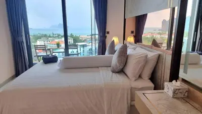 a hotel room with a bed and a large window at Silk Ao Nang Condominium in Ao Nang Beach