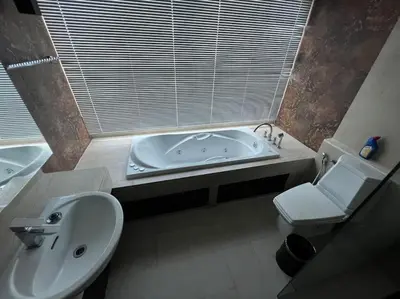 a bathroom with a tub and a toilet and a sink at Luxurious 3BR Penthouse Jacuzzi Seaview in Kamala Beach