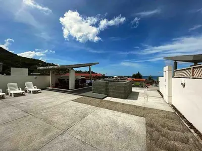 a patio with two chairs and a gazebo at Luxurious 3BR Penthouse Jacuzzi Seaview in Kamala Beach