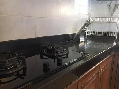 a stove top with two pans on it in a kitchen at Exquisite 3BR Private Pool Villa: Prime Location in Kamala Beach