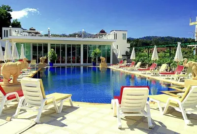 a group of chairs and a swimming pool at Stunning 4-BR House with Inviting Swimming Pool in Kamala Beach